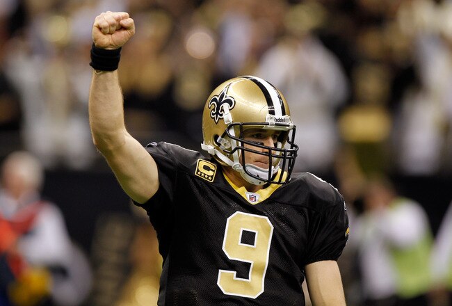 NEW ORLEANS, LA - DECEMBER 26:  Quarterback Drew Brees #9 of the New Orleans Saints reacts after throwing a nine-yard touchdown pass to running back Darren Sproles #43 and breaks the single-season passing record in the fourth quarter against the Atlanta Falcons at the Mercedes-Benz Superdome on December 26, 2011 in New Orleans, Louisiana.  (Photo by Chris Graythen/Getty Images)