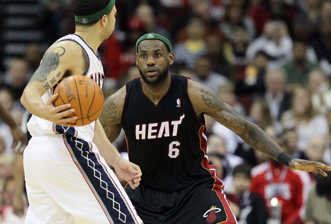 NEWARK, NJ - APRIL 03:  LeBron James #6 of the Miami Heat defends against Deron Williams #8 of the New Jersey Nets at the Prudential Center on April 3, 2011 in Newark, New Jersey.The Heat defeated the Nets 108-94.NOTE TO USER: User expressly acknowledges and agrees that, by downloading and/or using this Photograph, user is consenting to the terms and conditions of the Getty Images License Agreement.  (Photo by Jim McIsaac/Getty Images)