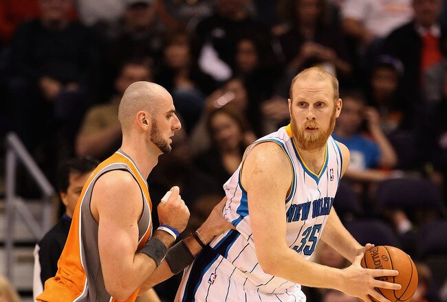 PHOENIX, AZ - DECEMBER 26:  Chris Kaman #35 of the New Orleans Hornets handles the ball during the season openning NBA game against the Phoenix Suns at US Airways Center on December 26, 2011 in Phoenix, Arizona.  The Hornets defeated the Suns 85-84. NOTE TO USER: User expressly acknowledges and agrees that, by downloading and or using this photograph, User is consenting to the terms and conditions of the Getty Images License Agreement.  (Photo by Christian Petersen/Getty Images)