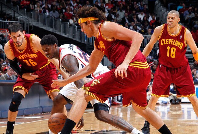 ATLANTA, GA - JANUARY 21:  Marvin Williams #24 of the Atlanta Hawks battles for a loose ball against Omri Casspi #36 and Anderson Varejao #17 of the Cleveland Cavaliers at Philips Arena on January 21, 2012 in Atlanta, Georgia.  NOTE TO USER: User expressly acknowledges and agrees that, by downloading and or using this photograph, User is consenting to the terms and conditions of the Getty Images License Agreement.  (Photo by Kevin C. Cox/Getty Images)