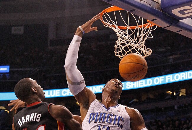 ORLANDO, FL - DECEMBER 21: Dwight Howard #12 of the Orlando Magic dunks over Terrel Harris #14 of the Miami Heat during a preseason game at Amway Center on December 21, 2011 in Orlando, Florida. NOTE TO USER: User expressly acknowledges and agrees that, by downloading and/or using this Photograph, User is consenting to the terms and conditions of the Getty Images License Agreement.  (Photo by Mike Ehrmann/Getty Images)