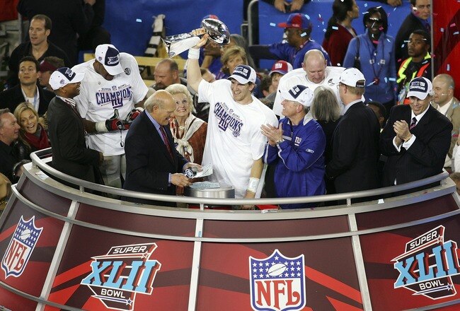 GLENDALE, AZ - FEBRUARY 03:  Quarterback Eli Manning #10 of the New York Giants holds the Vince Lombardi Trophy after defeating the New England Patriots 17 0 14 after Super Bowl XLII on February 3, 2008 at the University of Phoenix Stadium in Glendale, Arizona.  (Photo by Jim McIsaac/Getty Images)