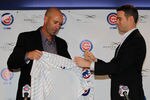 CHICAGO, IL - NOVEMBER 18:  President Theo Epstein of the Chicago Cubs helps new manager Dale Sveum with his jersey during a press conference at Wrigley Field on November 18, 2011 in Chicago, Illinois.  (Photo by Jonathan Daniel/Getty Images)