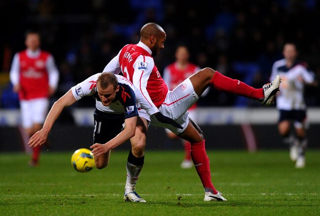 BOLTON, ENGLAND - FEBRUARY 01:  Thierry Henry of Arsenal tangles with David Wheater of Bolton Wanderers during the Barclays Premier League match between Bolton Wanderers and Arsenal at the Reebok Stadium on February 1, 2012 in Bolton, England.  (Photo by Laurence Griffiths/Getty Images)
