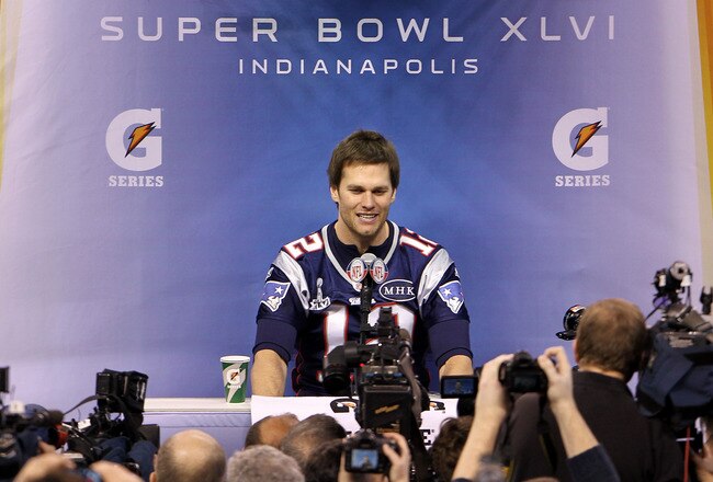 INDIANAPOLIS, IN - JANUARY 31:  Tom Brady #12 of the New England Patriotsanswers questions from the media during Media Day ahead of Super Bowl XLVI against the New York Giants at Lucas Oil Stadium on January 31, 2012 in Indianapolis, Indiana.  (Photo by Michael Heiman/Getty Images)