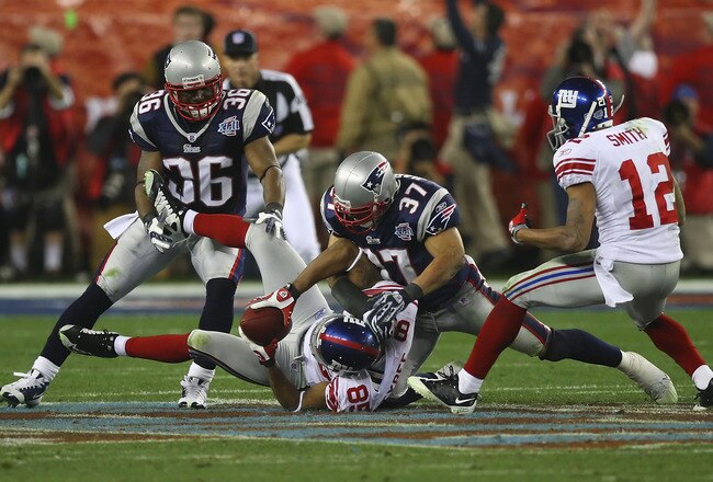 GLENDALE, AZ - FEBRUARY 03:  David Tyree #85 of the New York Giants catches a 32-yard pass from Eli Manning #10 as Rodney Harrison #37 of the New England Patriots comes down on him in the fourth quarter of Super Bowl XLII on February 3, 2008 at the University of Phoenix Stadium in Glendale, Arizona.  (Photo by Donald Miralle/Getty Images)