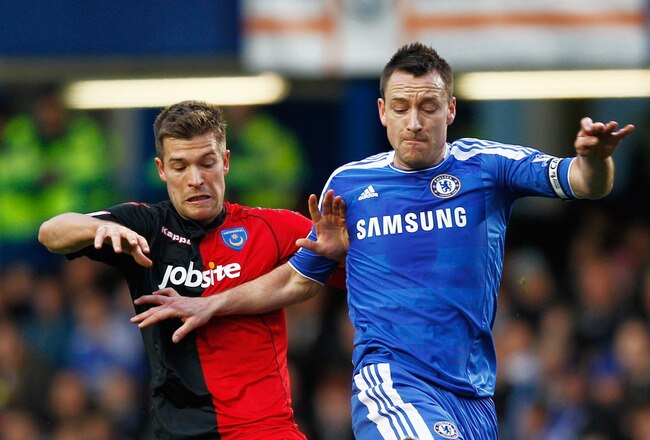 LONDON, ENGLAND - JANUARY 08:  John Terry of Chelsea battles with Marko Futacs of Portsmouth during the FA Cup sponsored by Budweiser Third Round match between Chelsea and Portsmouth at Stamford Bridge on January 8, 2012 in London, England.  (Photo by Paul Gilham/Getty Images)