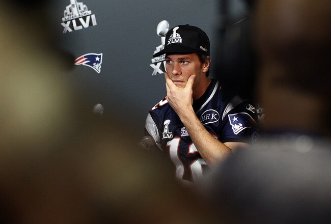 INDIANAPOLIS, IN - FEBRUARY 02:  Tom Brady #12 of the New England Patriots answers questions from the press during a media availability session for Super Bowl XLVI at the University Place Conference Center & Hotel on February 2, 2012 in Indianapolis, Indiana.  (Photo by Win McNamee/Getty Images)