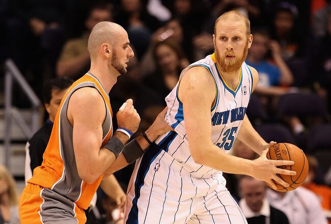 PHOENIX, AZ - DECEMBER 26:  Chris Kaman #35 of the New Orleans Hornets handles the ball during the season openning NBA game against the Phoenix Suns at US Airways Center on December 26, 2011 in Phoenix, Arizona.  The Hornets defeated the Suns 85-84. NOTE TO USER: User expressly acknowledges and agrees that, by downloading and or using this photograph, User is consenting to the terms and conditions of the Getty Images License Agreement.  (Photo by Christian Petersen/Getty Images)