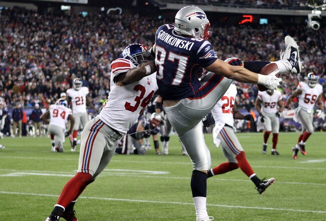 FOXBORO, MA - NOVEMBER 06:  Dan Gronkowski #87 of the New England Patriots tries to hang on to the ball for the touchdown but drops it as he is tackled by Deon Grant #34 of the New York Giants on November 6, 2011 at Gillette Stadium in Foxboro, Massachusetts. The New York Giants defeated the New England Patriots 24-20.  (Photo by Elsa/Getty Images)