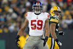 GREEN BAY, WI - JANUARY 15:  Michael Boley #59 of the New York Giants reacts after a sack in the fourth quarter against the Green Bay Packers during their NFC Divisional playoff game at Lambeau Field on January 15, 2012 in Green Bay, Wisconsin.  (Photo by Jamie Squire/Getty Images)