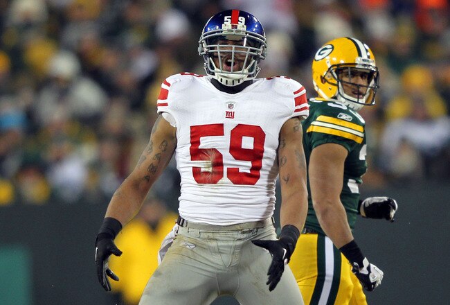 GREEN BAY, WI - JANUARY 15:  Michael Boley #59 of the New York Giants reacts after a sack in the fourth quarter against the Green Bay Packers during their NFC Divisional playoff game at Lambeau Field on January 15, 2012 in Green Bay, Wisconsin.  (Photo by Jamie Squire/Getty Images)