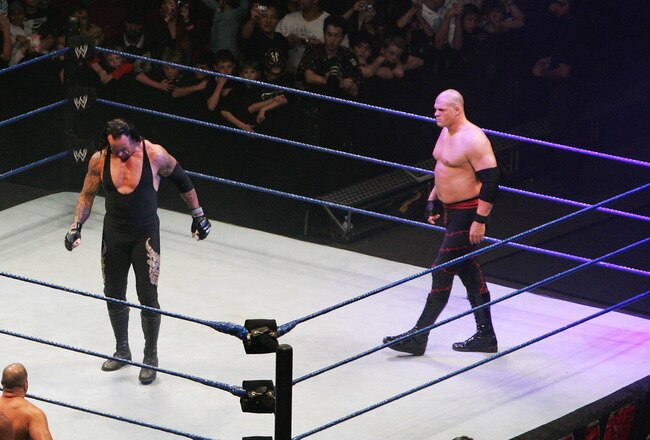 SYDNEY, AUSTRALIA - JUNE 15:  The Undertaker and ECW Champion Kane stand in the ring as the look down to Bam Neely, Chavo Guerrero, and The Great Khali during WWE Smackdown at Acer Arena on June 15, 2008 in Sydney, Australia.  (Photo by Gaye Gerard/Getty Images)