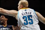 NEW ORLEANS, LA - JANUARY 18:  O.J. Mayo #32 of the Memphis Grizzlies shoots the ball around Chris Kaman #35 of the New Orleans Hornets at New Orleans Arena on January 18, 2012 in New Orleans, Louisiana.  NOTE TO USER: User expressly acknowledges and agrees that, by downloading and or using this photograph, User is consenting to the terms and conditions of the Getty Images License Agreement.  (Photo by Chris Graythen/Getty Images)