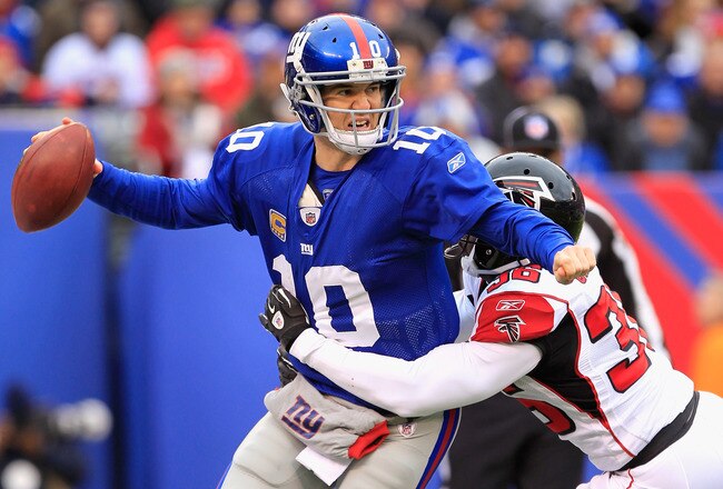 EAST RUTHERFORD, NJ - JANUARY 08:  James Sanders #36 of the Atlanta Falcons tackles Eli Manning #10 of the New York Giants for a safety as Manning was called for intentianal grounding in the end zone in the first quarter during their NFC Wild Card Playoff game at MetLife Stadium on January 8, 2012 in East Rutherford, New Jersey.  (Photo by Chris Trotman/Getty Images)