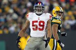 GREEN BAY, WI - JANUARY 15:  Michael Boley #59 of the New York Giants reacts after a sack in the fourth quarter against the Green Bay Packers during their NFC Divisional playoff game at Lambeau Field on January 15, 2012 in Green Bay, Wisconsin.  (Photo by Jamie Squire/Getty Images)