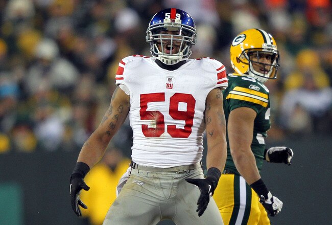 GREEN BAY, WI - JANUARY 15:  Michael Boley #59 of the New York Giants reacts after a sack in the fourth quarter against the Green Bay Packers during their NFC Divisional playoff game at Lambeau Field on January 15, 2012 in Green Bay, Wisconsin.  (Photo by Jamie Squire/Getty Images)