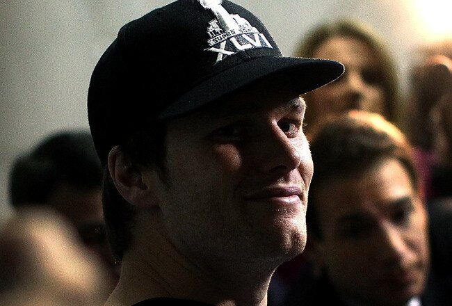 INDIANAPOLIS, IN - FEBRUARY 02:  Tom Brady #12 of the New England Patriots answers questions from the press during a media availability session for Super Bowl XLVI at the University Place Conference Center & Hotel on February 2, 2012 in Indianapolis, Indiana.  (Photo by Win McNamee/Getty Images)