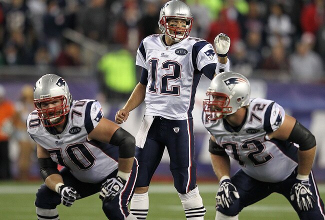 FOXBORO, MA - OCTOBER 16: Tom Brady #12 of the New England Patriots gestures as Logan Mankins #70 of the New England Patriots and Matt Light #72 of the New England Patriots hold their position against the Dallas Cowboys at Gillette Stadium on October 16, 2011 in Foxboro, Massachusetts. The Patriots won 20-16. (Photo by Jim Rogash/Getty Images)