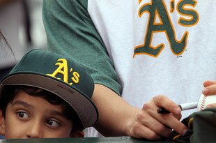 OAKLAND, CA - APRIL 01:  Fans wait for autographs before the start of the Opening Day game with the Oakland Athletics and the Seattle Mariners at the Oakland-Alameda County Coliseum on April 1, 2011 in Oakland, California  (Photo by Justin Sullivan/Getty Images)