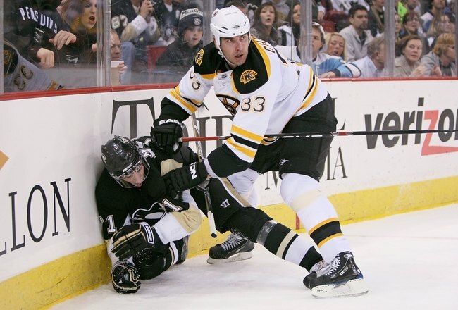 PITTSBURGH - DECEMBER 30: Defenseman Zdeno Chara #33 of the Boston Bruins checks forward Evgeni Malkin #71 of the Pittsburgh Penguins on December 30, 2008 at Mellon Arena in Pittsburgh, Pennsylvania.  (Photo by Jamie Sabau/Getty Images)
