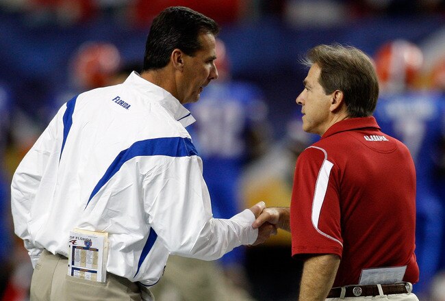 ATLANTA - DECEMBER 06:  Head coach Nick Saban of the Alabama Crimson Tide shakes hands with Urban Meyer, head coach of the Florida Gators before the start of the SEC Championship on December 6, 2008 at the Georgia Dome in Atlanta, Georgia.  (Photo by Chris Graythen/Getty Images)