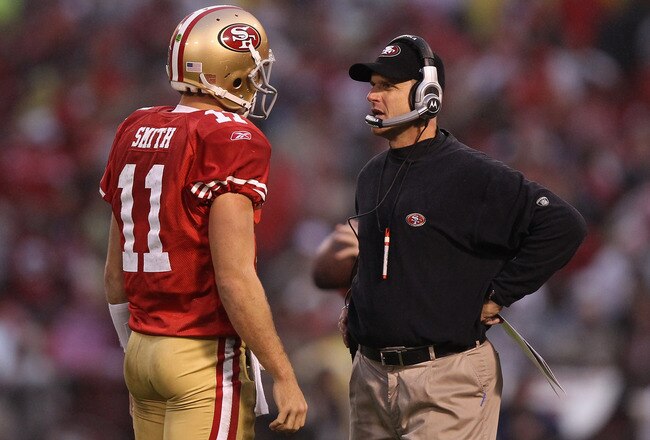 SAN FRANCISCO, CA - JANUARY 22:  (L-R) Alex Smith #11 and head coach Jim Harbaugh of the San Francisco 49ers talk during a timeout against the New York Giants in the second quarter during the NFC Championship Game at Candlestick Park on January 22, 2012 in San Francisco, California.  (Photo by Ezra Shaw/Getty Images)