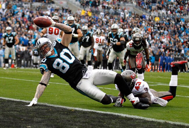 CHARLOTTE, NC - DECEMBER 24:  Jeremy Shockey #80 of the Carolina Panthers dives for a touchdown against Ahmad Black #43 of the Tampa Bay Buccaneers during their game at Bank of America Stadium on December 24, 2011 in Charlotte, North Carolina.  (Photo by Streeter Lecka/Getty Images)