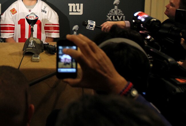 INDIANAPOLIS, IN - FEBRUARY 01:  Eli Manning #10 of the New York Giants answers questions from the press during a media availability session for Super Bowl XLVI at the Indianapolis Downtown Marriott on February 1, 2012 in Indianapolis, Indiana.  (Photo by Andy Lyons/Getty Images)