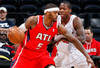ATLANTA, GA - JANUARY 16:  Josh Smith #5 of the Atlanta Hawks drives against Ed Davis #32 of the Toronto Raptors at Philips Arena on January 16, 2012 in Atlanta, Georgia.  NOTE TO USER: User expressly acknowledges and agrees that, by downloading and or using this photograph, User is consenting to the terms and conditions of the Getty Images License Agreement.  (Photo by Kevin C. Cox/Getty Images)