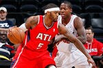 ATLANTA, GA - JANUARY 16:  Josh Smith #5 of the Atlanta Hawks drives against Ed Davis #32 of the Toronto Raptors at Philips Arena on January 16, 2012 in Atlanta, Georgia.  NOTE TO USER: User expressly acknowledges and agrees that, by downloading and or using this photograph, User is consenting to the terms and conditions of the Getty Images License Agreement.  (Photo by Kevin C. Cox/Getty Images)