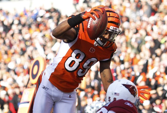 CINCINNATI, OH - DECEMBER 24: Jerome Simpson #89 of the Cincinnati Bengals jumps over Daryl Washington #58 of the Arizona Cardinals for a 19-yard touchdown during first half action at Paul Brown Stadium on December 24, 2011 in Cincinnati, Ohio. (Photo by Joe Robbins/Getty Images)