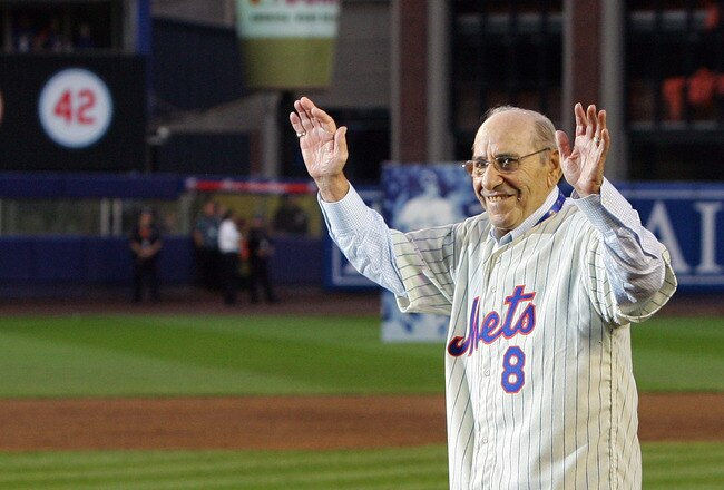 NEW YORK - SEPTEMBER 28:  Former Mets manager Yogi Berra greets fans from the field in a post game ceremony after the last regular season baseball game ever played in Shea Stadium against the Florida Marlins on September 28, 2008 in the Flushing neighborhood of the Queens borough of New York City. The Mets plan to start next season at their new stadium Citi Field after playing in Shea for over 44 years.  (Photo by Jim McIsaac/Getty Images)