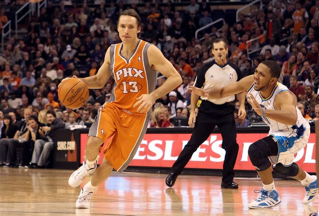 PHOENIX, AZ - DECEMBER 26:  Steve Nash #13 of the Phoenix Suns handles the ball during the season openning NBA game against the New Orleans Hornets at US Airways Center on December 26, 2011 in Phoenix, Arizona.  The Hornets defeated the Suns 85-84. NOTE TO USER: User expressly acknowledges and agrees that, by downloading and or using this photograph, User is consenting to the terms and conditions of the Getty Images License Agreement.  (Photo by Christian Petersen/Getty Images)