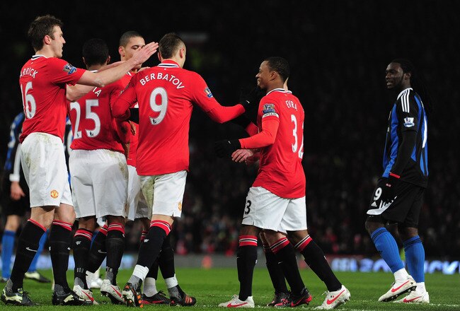 MANCHESTER, ENGLAND - JANUARY 31:  Dimitar Berbatov of Manchester United celebrates his goal with team mates during the Barclays Premier League match between Manchester United and Stoke City at Old Trafford on January 31, 2012 in Manchester, England.  (Photo by Jamie McDonald/Getty Images)