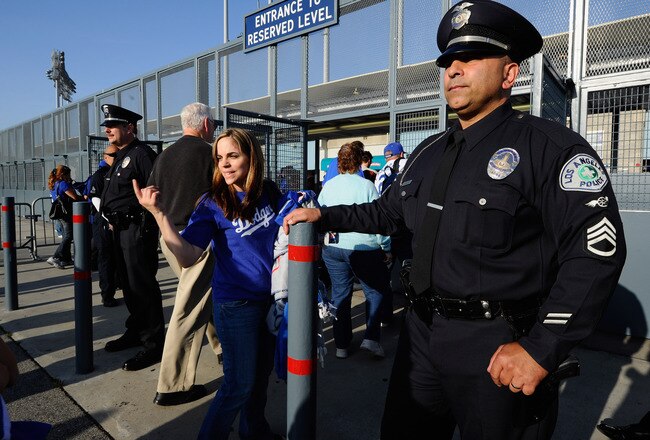 LOS ANGELES, CA - APRIL 14:  Los Angeles Police Department officers stand watch at an entrance to Dodger Stadium prior to the start of the baseball game between the St. Louis Cardinals and Los Angeles Dodgers on April 14, 2011 in Los Angeles, California. Large numbers of LAPD officers are being deployed as part of a zero tolerance policy toward misbehaving fans in response to the opening day attack on San Francisco Giants fan Bryan Stow two weeks ago.  (Photo by Kevork Djansezian/Getty Images)