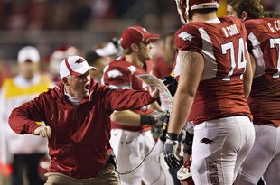FAYETTEVILLE, AR - NOVEMBER 12:   Head Coach Bobby Petrino of the Arkansas Razorbacks shows his offensive lineman something during a game against the Tennessee Volunteers at Donald W. Reynolds Stadium Stadium on November 12, 2011 in Fayetteville, Arkansas.  The Razorbacks defeated the Volunteers 49 to 7.  (Photo by Wesley Hitt/Getty Images)