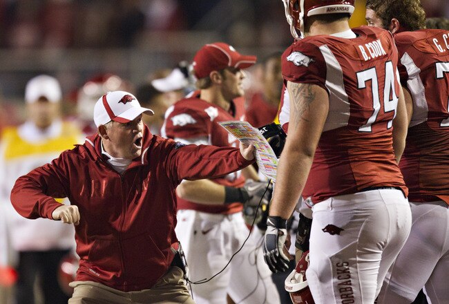 FAYETTEVILLE, AR - NOVEMBER 12:   Head Coach Bobby Petrino of the Arkansas Razorbacks shows his offensive lineman something during a game against the Tennessee Volunteers at Donald W. Reynolds Stadium Stadium on November 12, 2011 in Fayetteville, Arkansas.  The Razorbacks defeated the Volunteers 49 to 7.  (Photo by Wesley Hitt/Getty Images)