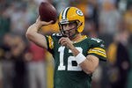 GREEN BAY, WI - SEPTEMBER 08:   Aaron Rodgers #12 of the Green Bay Packers warms before taking on the New Orleans Saints in the season opening game at Lambeau Field on September 8, 2011 in Green Bay, Wisconsin.  (Photo by Jonathan Daniel/Getty Images)