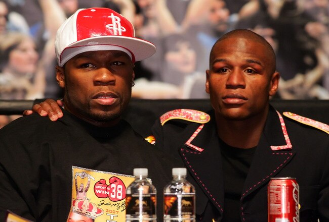 LAS VEGAS - MAY 05:  (L-R) Rapper 50 Cent and Floyd Mayweather Jr. embrace during the post-fight news conference after Mayweather defeated Oscar De La Hoya by split decision after their WBC super welterweight championship fight at the MGM Grand Garden Arena May 5, 2007 in Las Vegas, Nevada.  (Photo by Ethan Miller/Getty Images)