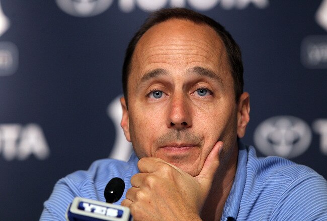NEW YORK, NY - JULY 08:  General manager Brian Cashman of the New York Yankees speaks to the media after the game against the Tampa Bay Rays was postponed due to rain on July 8, 2011 at Yankee Stadium in the Bronx borough of New York City.  (Photo by Jim McIsaac/Getty Images)