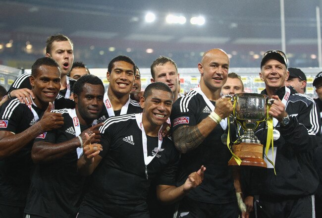WELLINGTON, NEW ZEALAND - FEBRUARY 04:  New Zealand captain DJ Forbes and coach Gordon Tietjens hold up the trophy after winning the Cup Final against Fiji on day two of the Wellington Sevens at Westpac Stadium on February 4, 2012 in Wellington, New Zealand.  (Photo by Phil Walter/Getty Images)