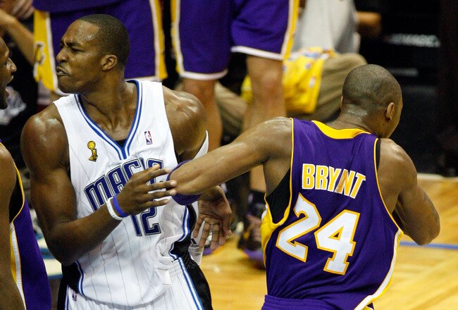 ORLANDO, FL - JUNE 11:  Dwight Howard #12 of the Orlando Magic and Kobe Bryant #24 of the Los Angeles Lakers exchange words in the third quarter in Game Four of the 2009 NBA Finals on June 11, 2009 at Amway Arena in Orlando, Florida.  NOTE TO USER:  User expressly acknowledges and agrees that, by downloading and or using this photograph, User is consenting to the terms and conditions of the Getty Images License Agreement.  (Photo by Ronald Martinez/Getty Images)