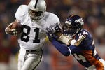 DENVER, CO - NOVEMBER 11:  Wide receiver Tim Brown #81 of the Oakland Raiders takes the ball to the sidelines against the Denver Broncos in the third quarter of Monday Night Football November 11, 2002 at Mile High Stadium in Denver, Colorado.  The Raiders won 34-10.  (Photo by Brian Bahr/Getty Images)