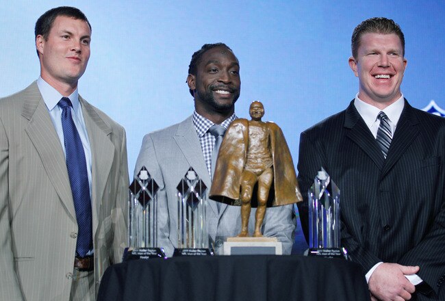 INDIANAPOLIS, IN - FEBRUARY 03:  (L to R) Philip Rivers of the San Diego Chargers, Charles Tillman of the Chicago Bears and Matt Birk of the Baltimore Ravens the three finalists for the Walter Payton NFL Man of the Year Award, pose with the trophy following a news conference on February 3, 2012 in Indianapolis, Indiana.  (Photo by Rob Carr/Getty Images)