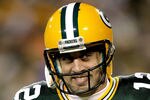 GREEN BAY, WI - DECEMBER 25:  Quarterback Aaron Rodgers #12 of the Green Bay Packers smiles as he leaves the field after a touchdown in the fourth quarter against the Chicago Bears at Lambeau Field on December 25, 2011 in Green Bay, Wisconsin.  (Photo by Matthew Stockman/Getty Images)