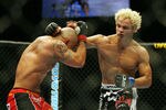 CHICAGO- OCTOBER 25: Josh Koscheck (R) punches Thiago Alves in a Welterweight bout  at UFC's Ultimate Fight Night at Allstate Arena on October 25, 2008 in Chicago, Illinois. (Photo by Tasos Katopodis/Getty Images)