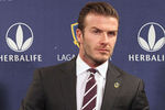 LOS ANGELES, CA - JANUARY 19:  Midfielder David Beckham gets ready in his seat for the press conference announcing his new contract with the Los Angeles Galaxy at Staples Center on January 19, 2012 in Los Angeles, California.  (Photo by Victor Decolongon/Getty Images)