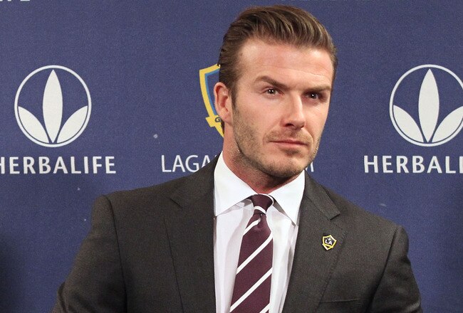 LOS ANGELES, CA - JANUARY 19:  Midfielder David Beckham gets ready in his seat for the press conference announcing his new contract with the Los Angeles Galaxy at Staples Center on January 19, 2012 in Los Angeles, California.  (Photo by Victor Decolongon/Getty Images)
