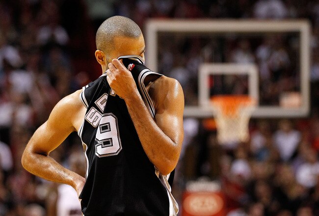 MIAMI, FL - JANUARY 17:  Tony Parker #9 of the San Antonio Spurs wipes his face during a game against the Miami Heat at American Airlines Arena on January 17, 2012 in Miami, Florida. NOTE TO USER: User expressly acknowledges and agrees that, by downloading and/or using this Photograph, User is consenting to the terms and conditions of the Getty Images License Agreement.  (Photo by Mike Ehrmann/Getty Images)